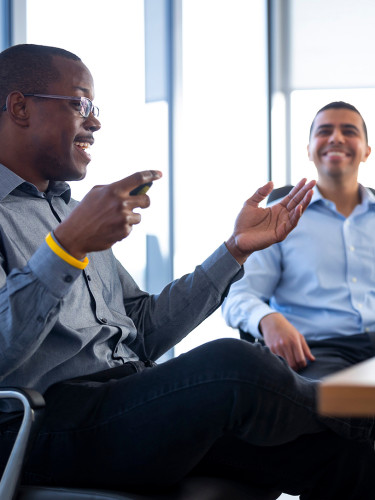 Three employees in a conference room discussing our sustainability governance