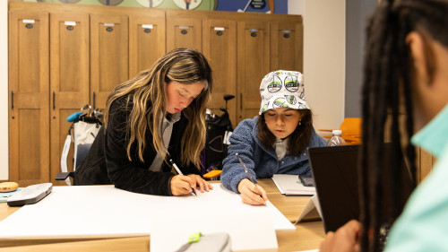 Students drawing on tablet