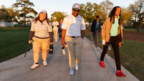 The group walking to the golf course