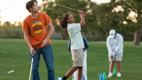 The students practicing their golf swing