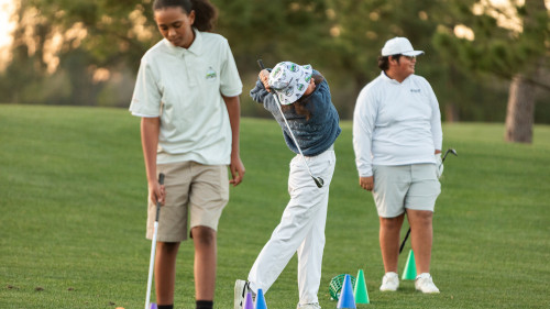 The students practicing their golf swing