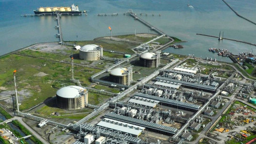 Aerial view of LNG plant and a ship in body of water
