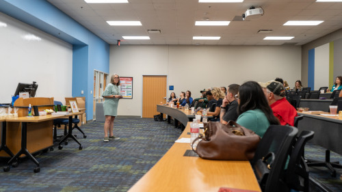 One of the students speaking in front of the rest of the participants.