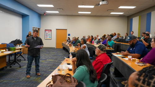 One of the students speaking in front of the rest of the participants.