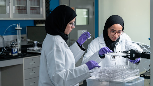 Process Lab, Scientist Eman and Engineer Mashael with Adsorption unit