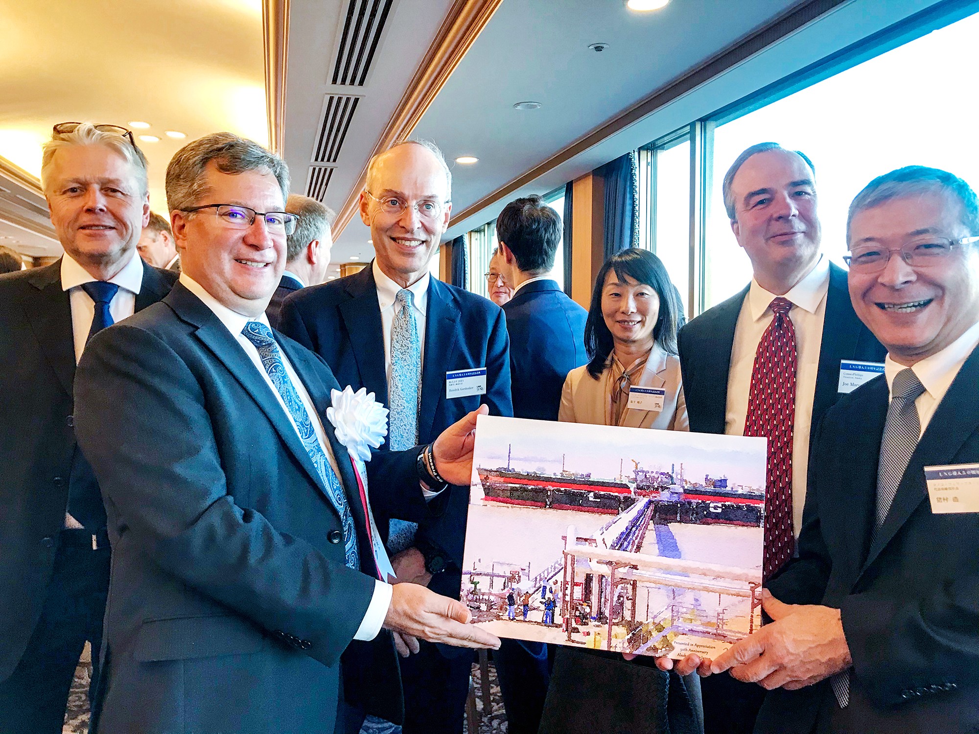 Bill Bullock admiring a photo of LNG tanker at the Kenai terminal 