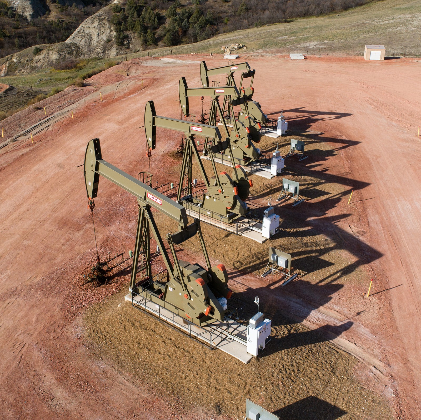 aerial view of 4 pump jacks side by side