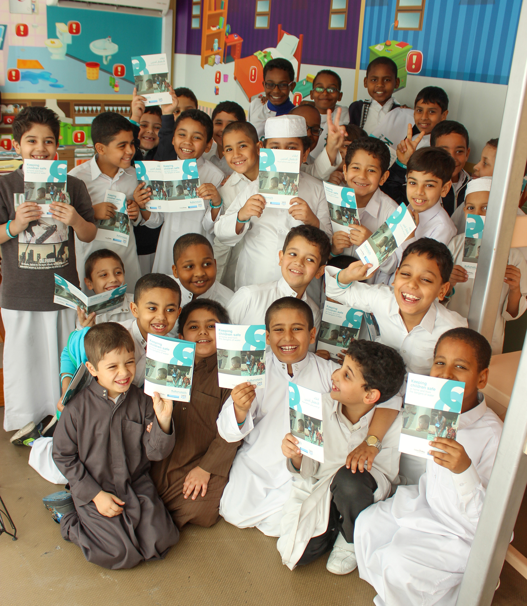 large group of children smiling and holding information sheets