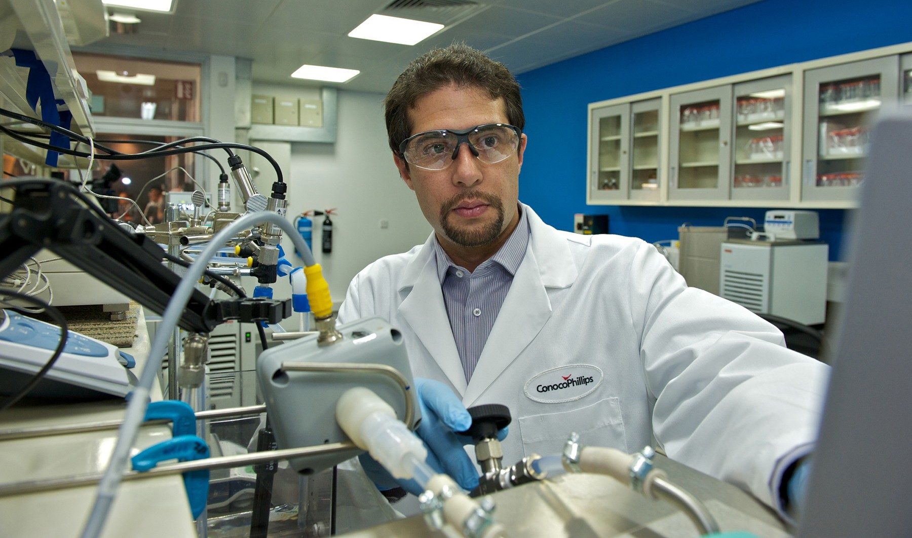 Joel Minier Matar handling equipment in the laboratory