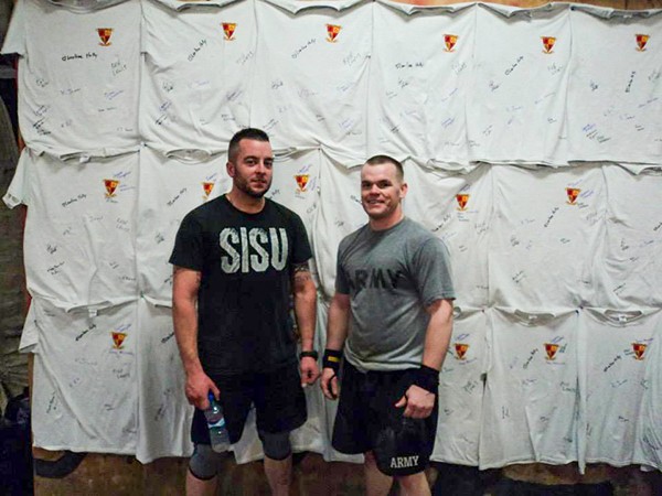 Two men standing in front of display