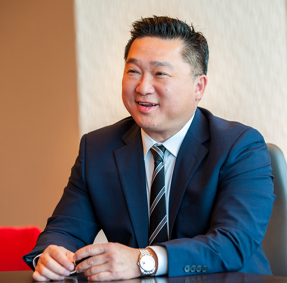 Khoa Dao sitting at a table in office setting