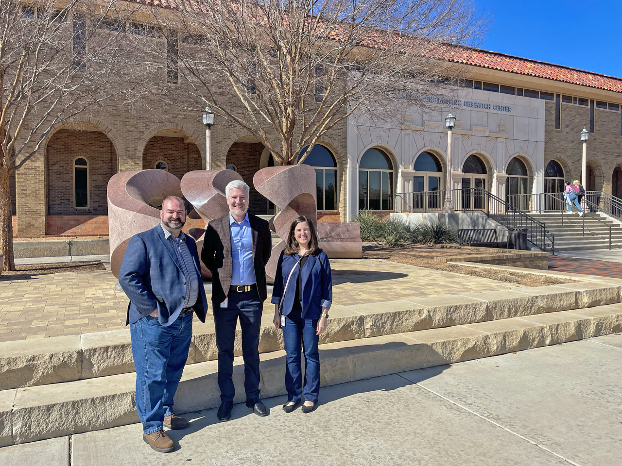 Group standing in front of the University building