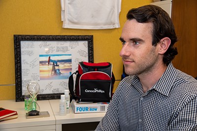 Ryan Moon in office setting, seated, looking left of frame