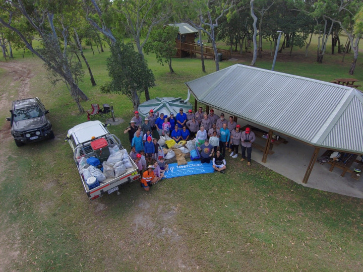 an aerial shot of the crew cleaning the beach
