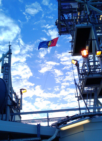 ship with a flag waving in the breeze