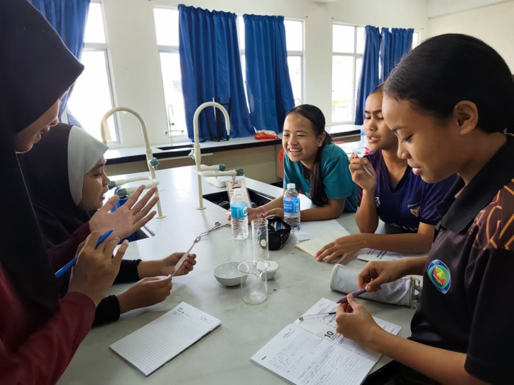 Students and instructors working through math equations.