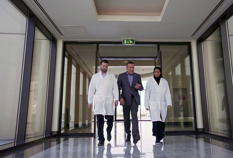 front view of three people walking down hallway