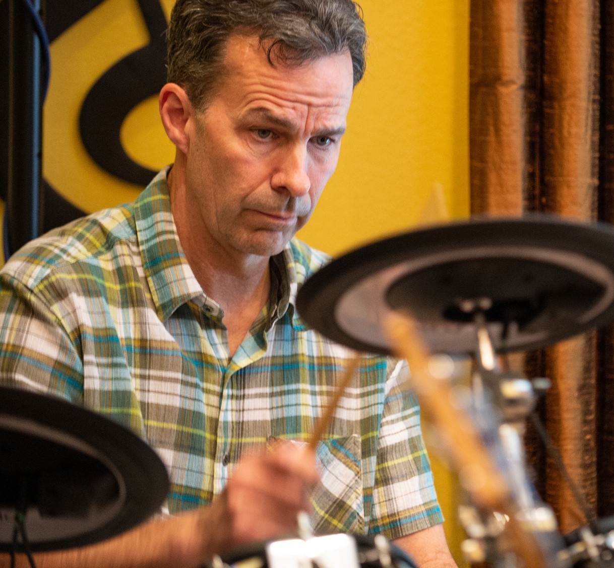 Bret Fossum concentrates while hitting cymbal.