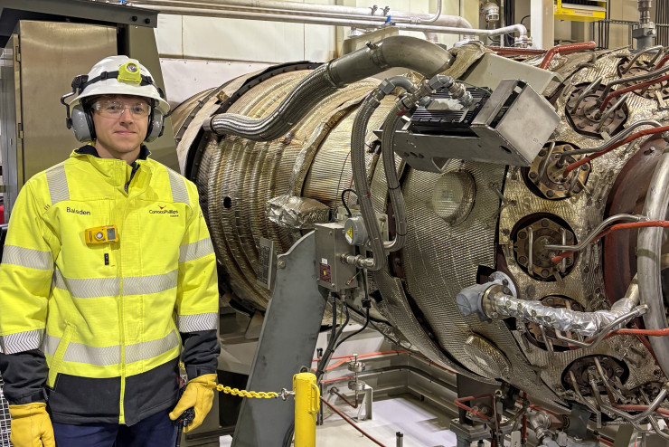 Alaska engineer James Baisden stands by a turbine generator at Alpine on the North Slope. 