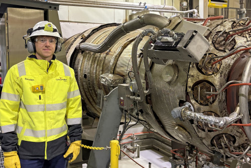 Alaska engineer James Baisden stands by a turbine generator at Alpine on the North Slope. 
