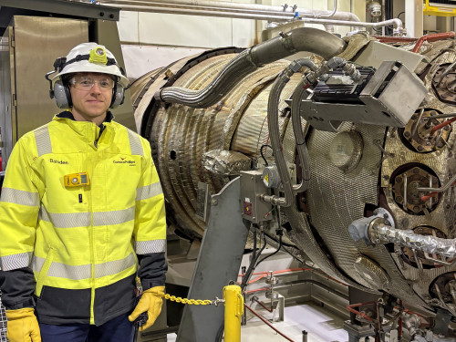 Alaska engineer James Baisden stands by a turbine generator at Alpine on the North Slope. 