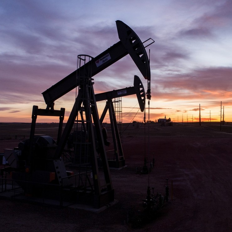 A silhouette image of oil wells.