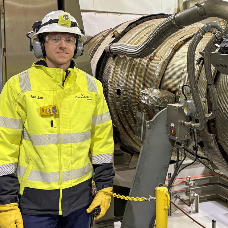 Alaska engineer James Baisden stands by a turbine generator at Alpine on the North Slope. 