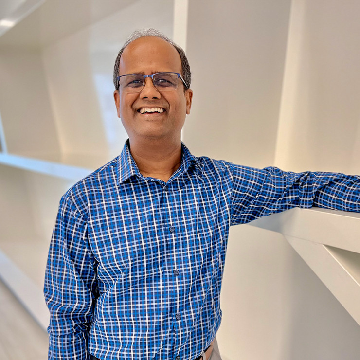 Shree Vikas, manager of Market Intelligence & Business Analysis, discussing energy markets and supply chain environment with a colleague at ConocoPhillips.
