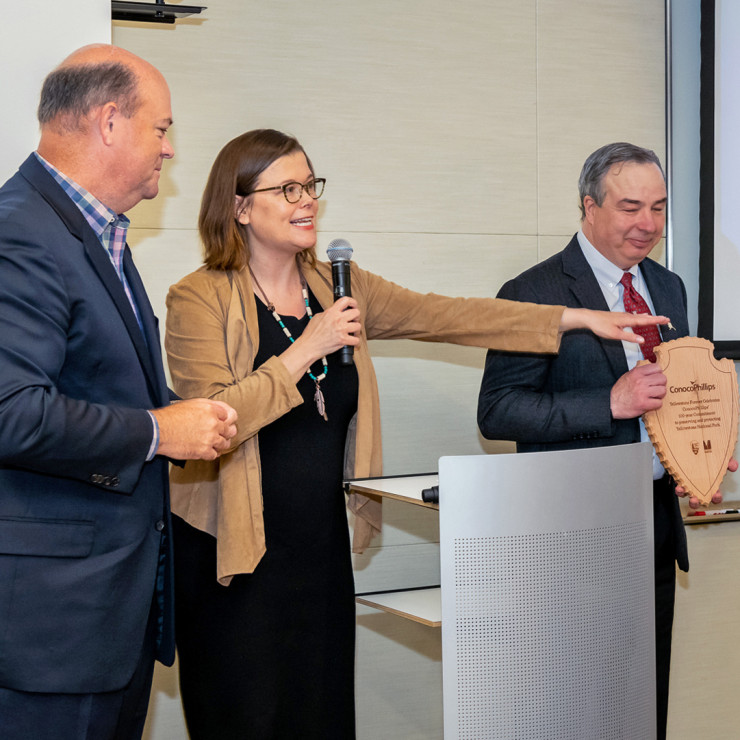 Heather White, president and CEO of Yellowstone Forever, second from left, and Meredith McMahon, director of corporate relations of Yellowstone Forever, present ConocoPhillips Chairman and CEO Ryan Lance, left, and Joe Marushack, president of the Alaska b