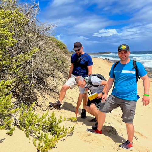 ConocoPhillips sedimentologist Dallin Laycock, right, along with Robert J. W. Mayer Arzuaga, a biology professor in the Department of Natural Sciences at the University of Puerto Rico Aguadilla, far left, and geologist Paul Bremner, center, examine sand a