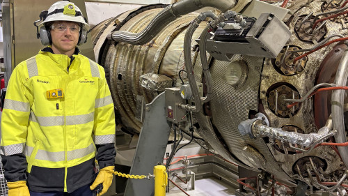 Alaska engineer James Baisden stands by a turbine generator at Alpine on the North Slope. 